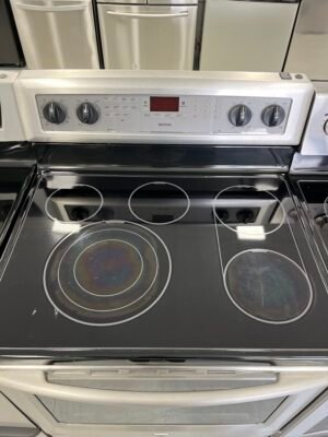 Side view of refurbished Maytag YMER8880BS stove for sale.